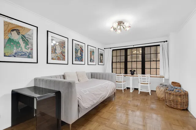 a bedroom with a large bed and a chandelier