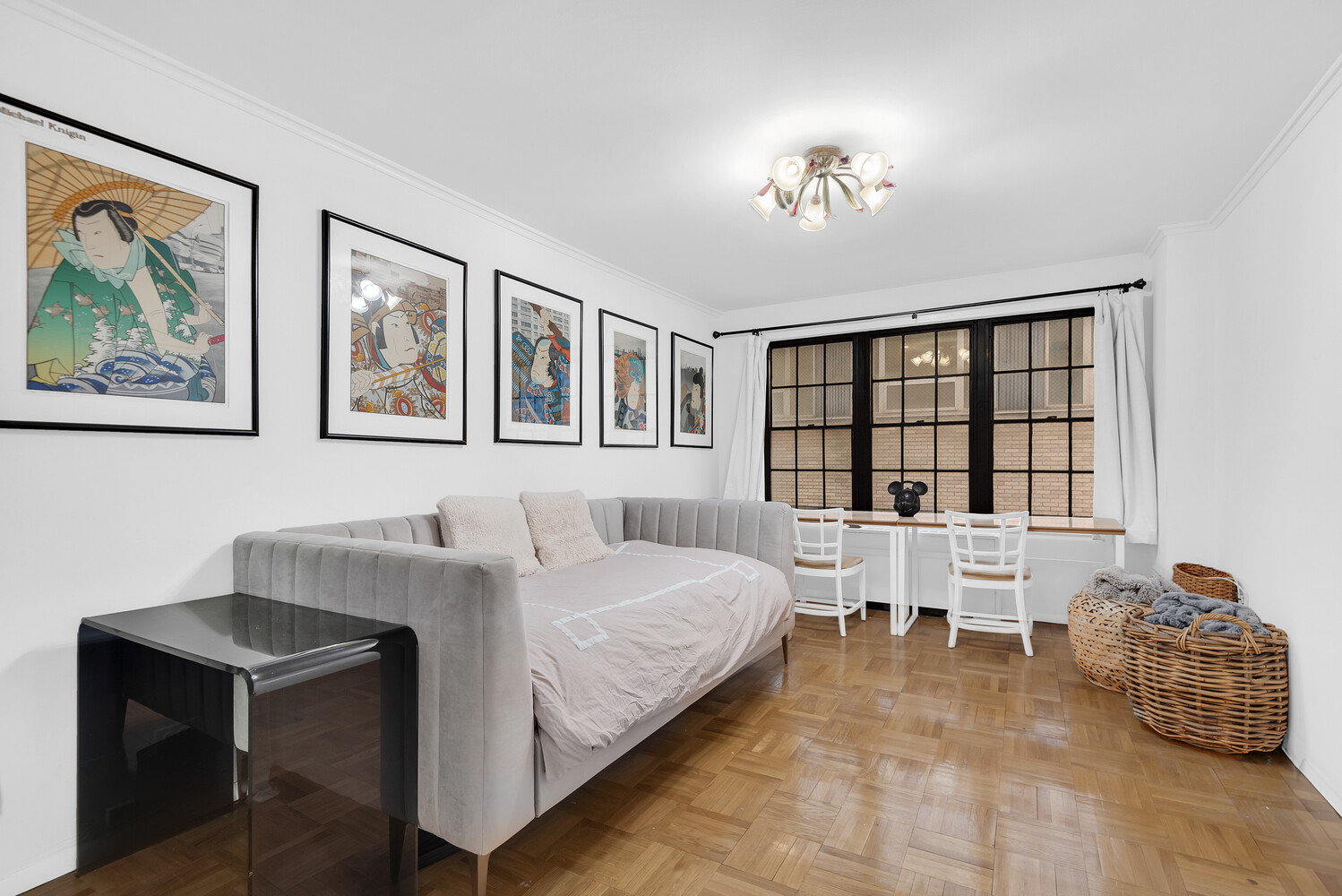 530 East 72nd Street, Unit 3F Manhattan, NY 10021 - Photo 12 of 16 a bedroom with a large bed and a chandelier