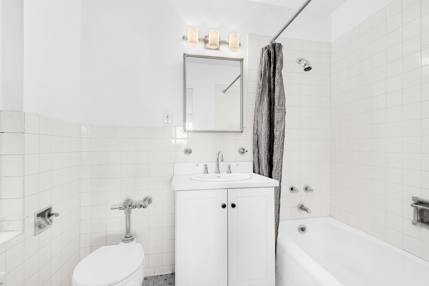 530 East 72nd Street, Unit 3F Manhattan, NY 10021 - Photo 14 of 16 a bathroom with a sink a toilet and shower
