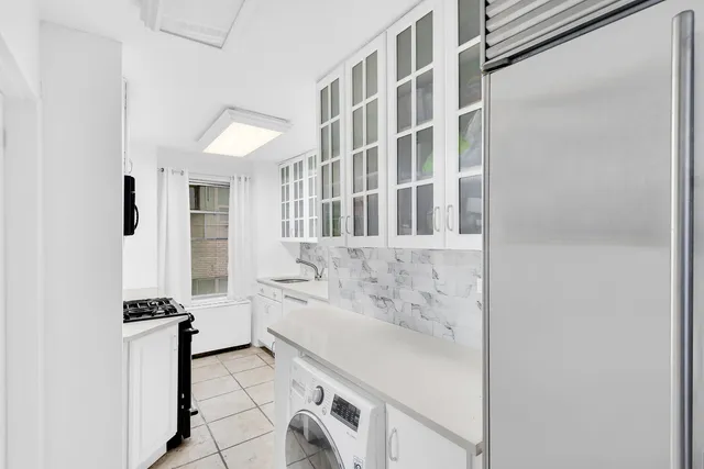a bathroom with a tub sink and a mirror