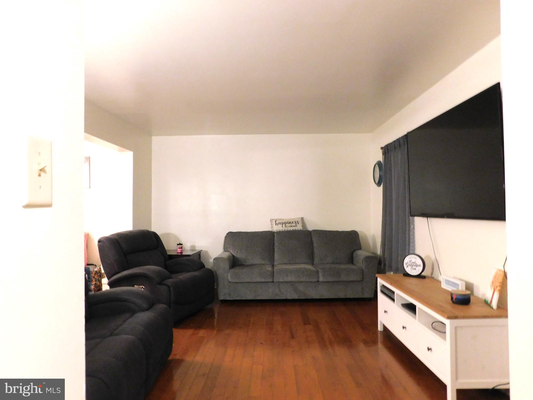 7 Hawthorn Way Clayton, NJ 08312 - Photo 3 of 11 a living room with furniture and a flat screen tv