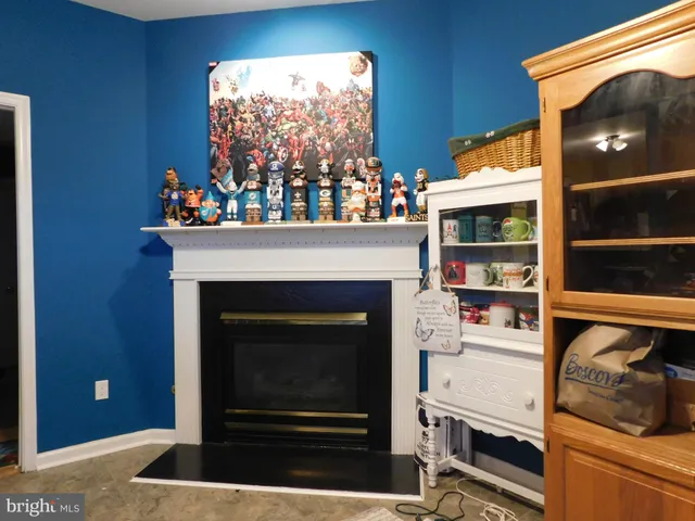 a living room with furniture a window and a fireplace