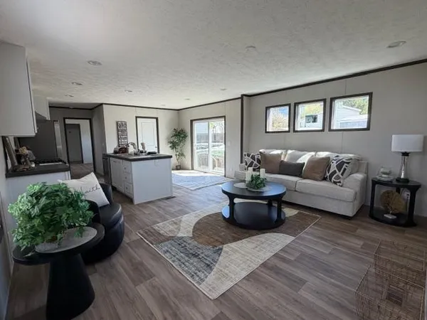 a living room with furniture and a potted plant