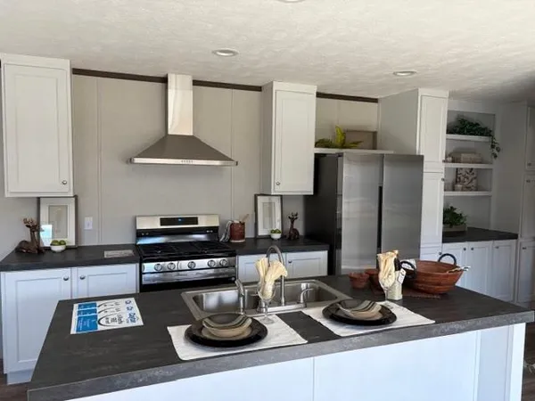 a kitchen with a sink stove and refrigerator
