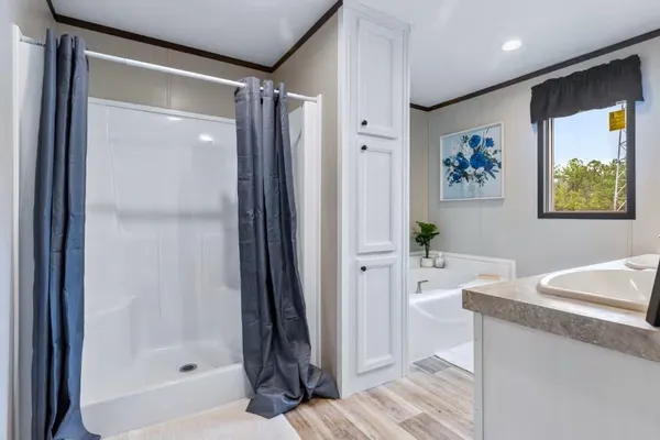 a bathroom with a tub and shower