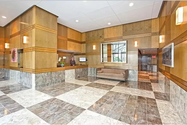 a bathroom with a toilet a sink a mirror and shower