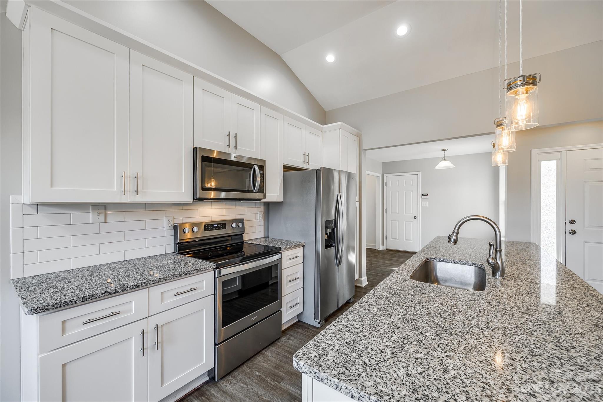 149 Airport Road Monroe, NC 28110 - Photo 11 of 41 a kitchen with granite countertop a stove a sink and a refrigerator