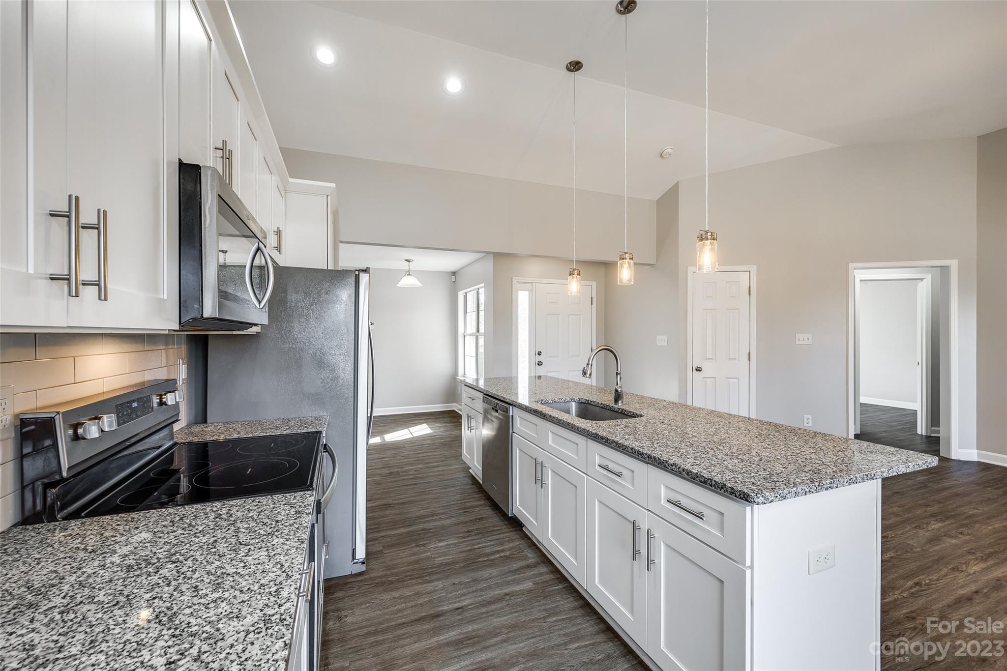 149 Airport Road Monroe, NC 28110 - Photo 12 of 41 a kitchen with stainless steel appliances granite countertop a sink stove and refrigerator