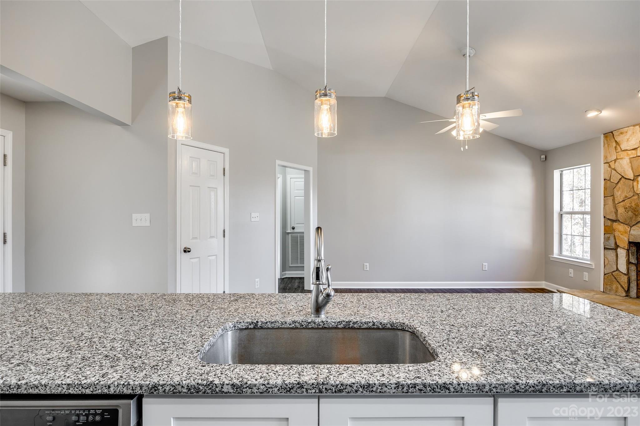 149 Airport Road Monroe, NC 28110 - Photo 15 of 41 a kitchen with a sink granite counter tops and a living room view
