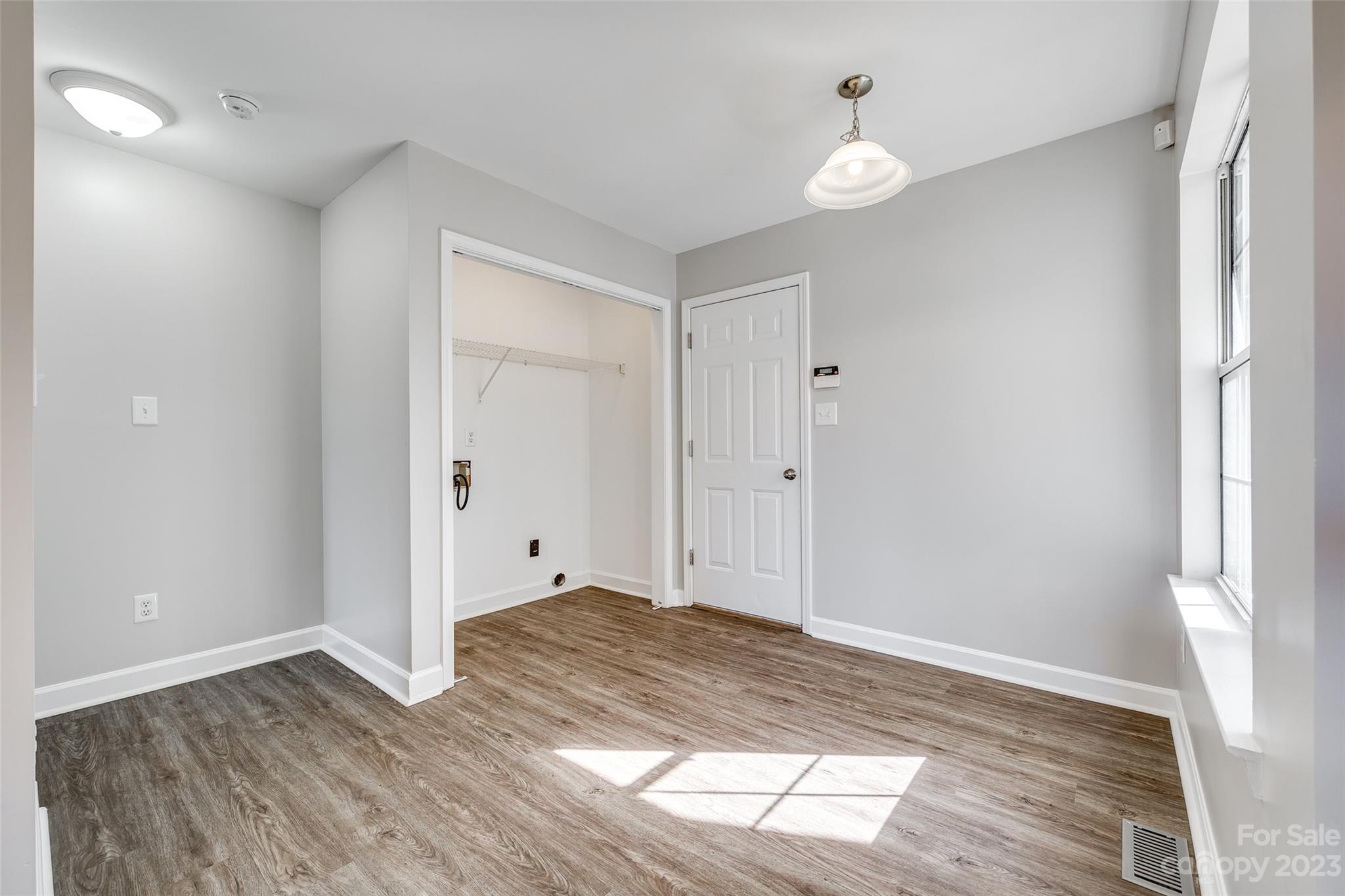 149 Airport Road Monroe, NC 28110 - Photo 17 of 41 a view of an empty room with wooden floor and a window
