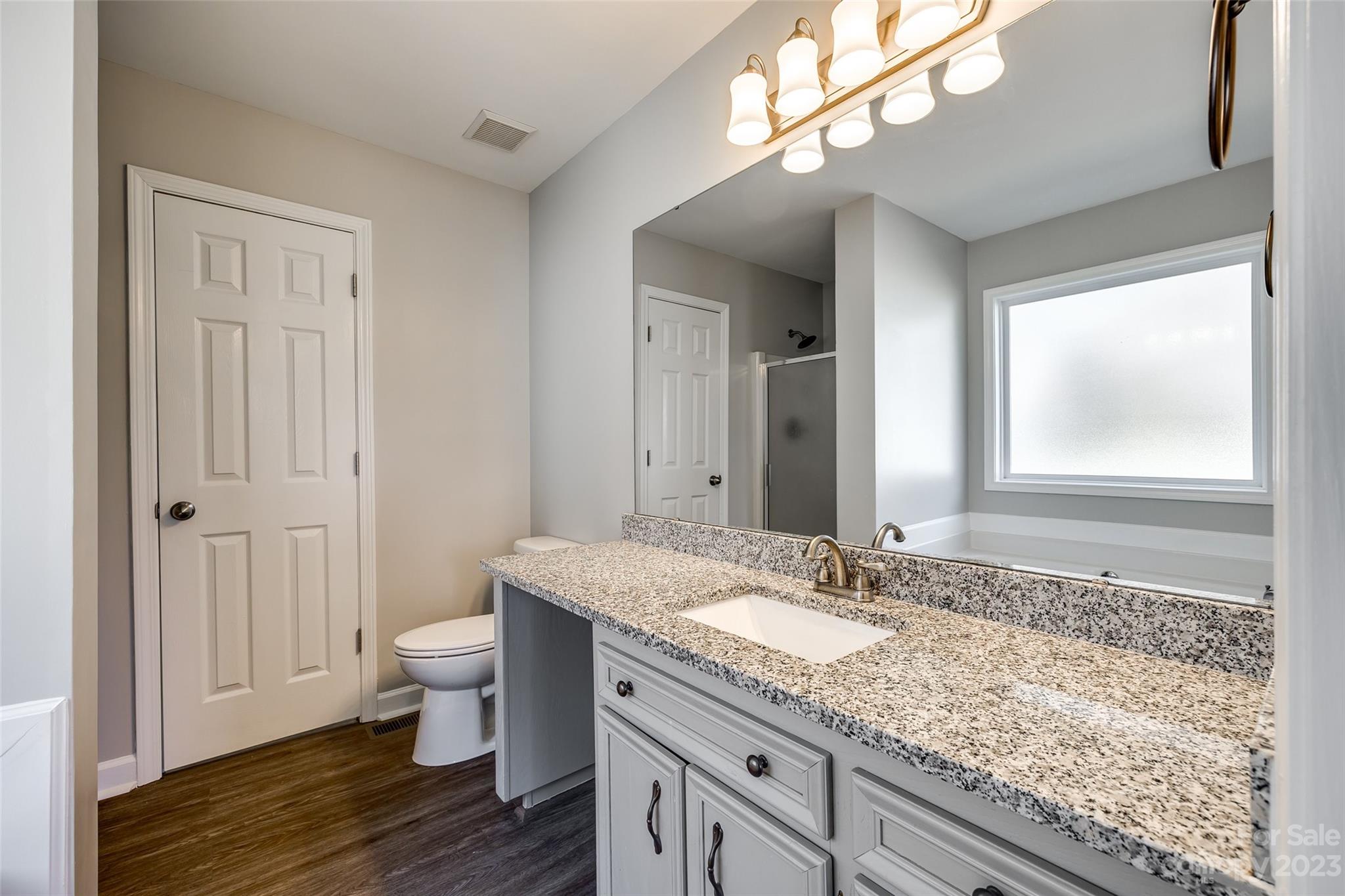 149 Airport Road Monroe, NC 28110 - Photo 20 of 41 a bathroom with a granite countertop sink a toilet and a mirror