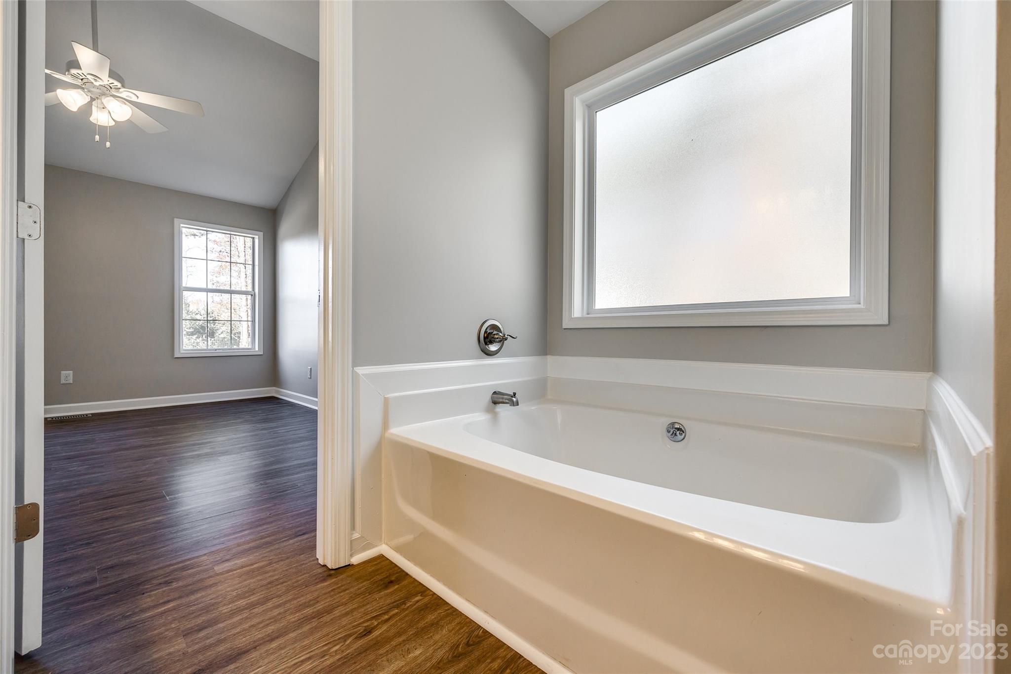 149 Airport Road Monroe, NC 28110 - Photo 22 of 41 a spacious bathroom with windows and bathtub
