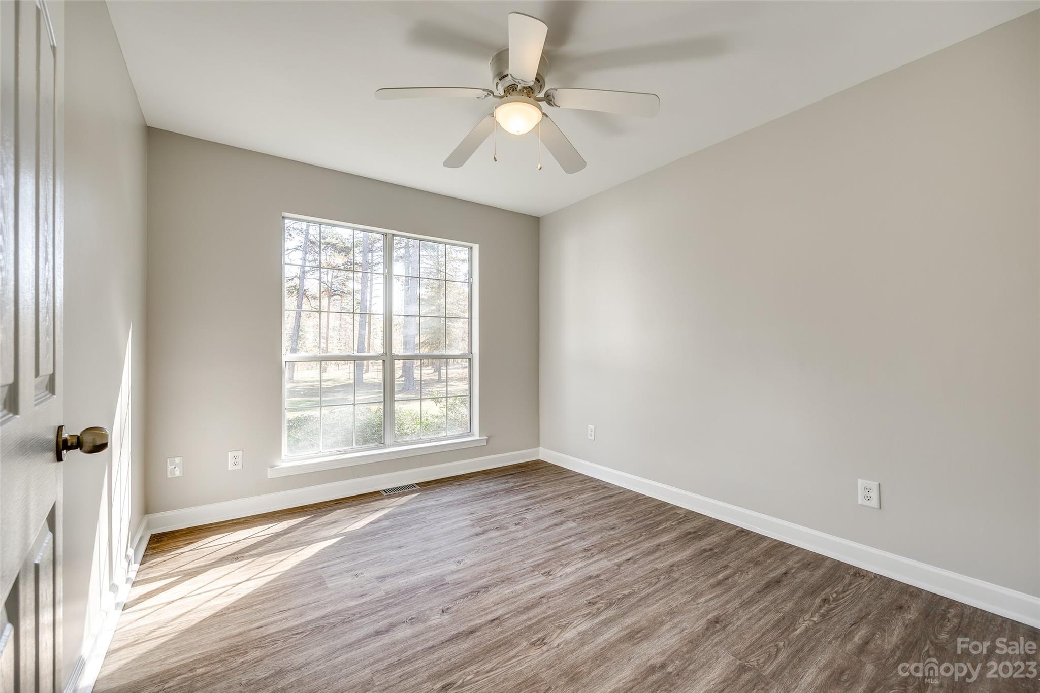 149 Airport Road Monroe, NC 28110 - Photo 26 of 41 an empty room with wooden floor and windows