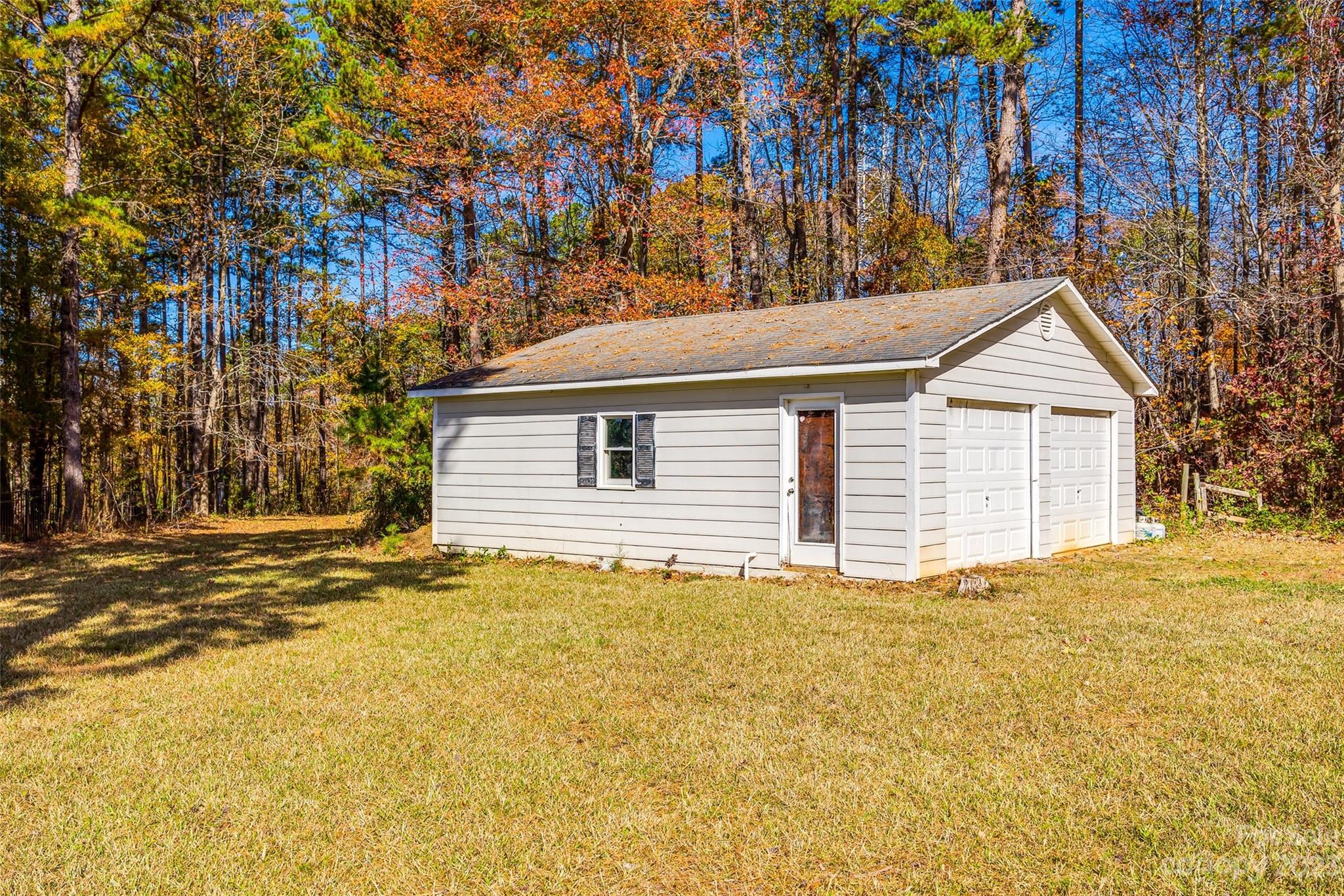 149 Airport Road Monroe, NC 28110 - Photo 33 of 41 a view of a house with a yard and garage