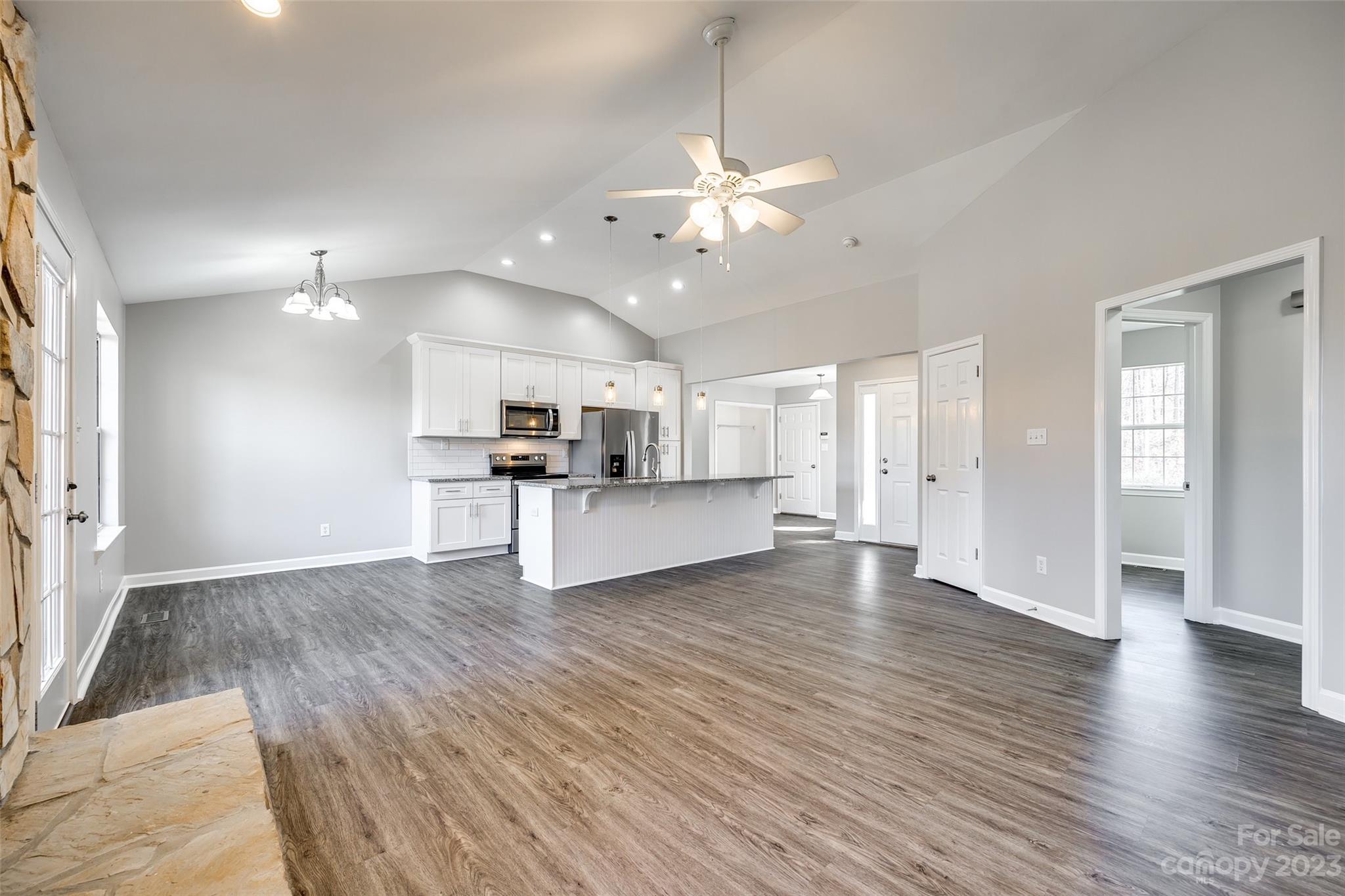 149 Airport Road Monroe, NC 28110 - Photo 6 of 41 a view of an empty room and kitchen with wooden floor