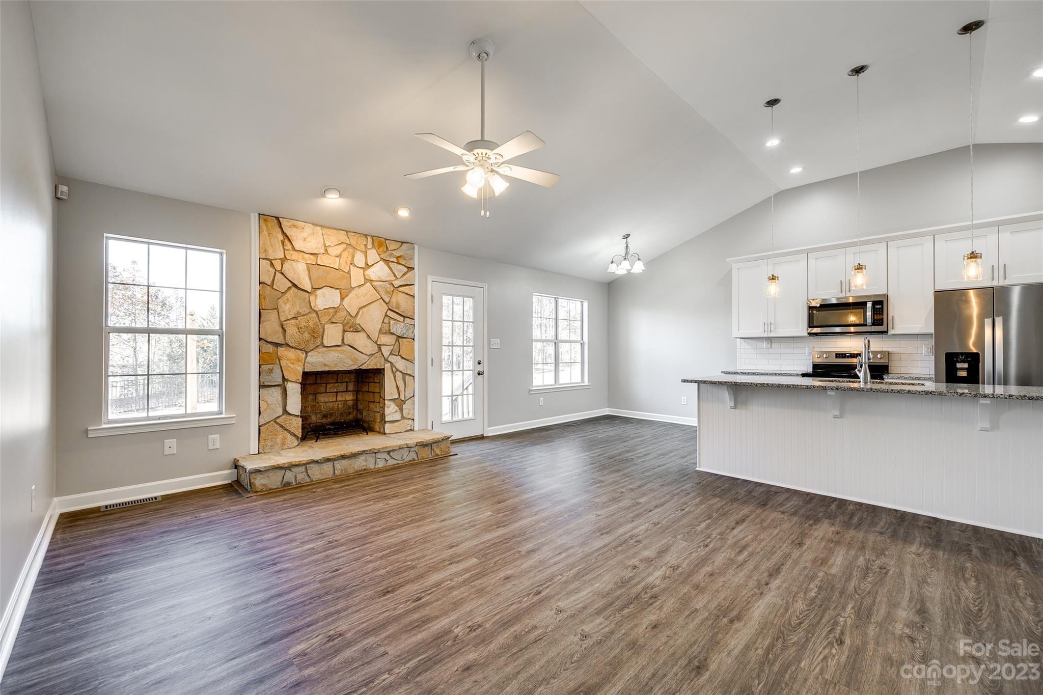 149 Airport Road Monroe, NC 28110 - Photo 7 of 41 a view of an empty room with a kitchen and a fireplace