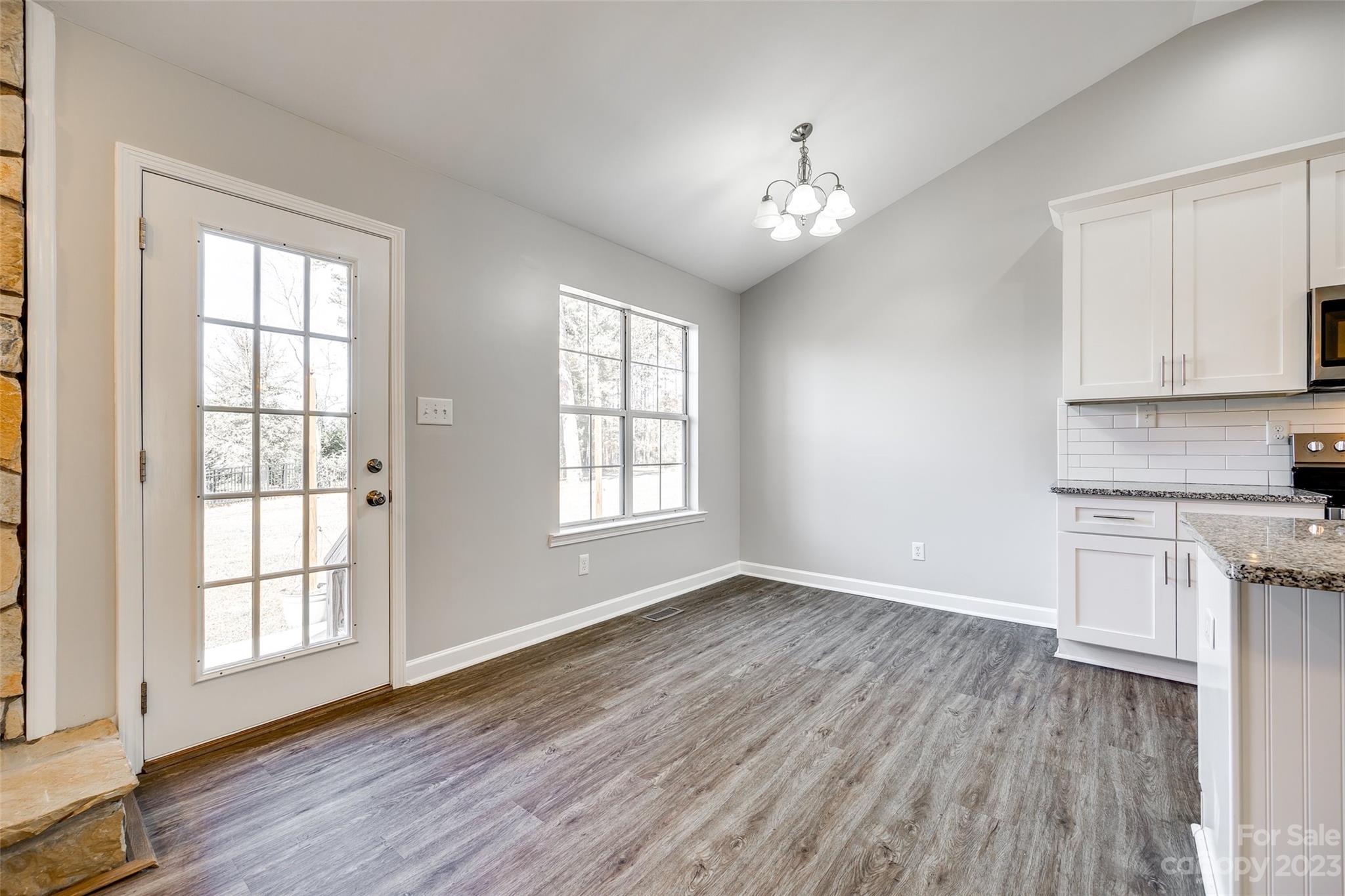 149 Airport Road Monroe, NC 28110 - Photo 9 of 41 an empty room with wooden floor and windows