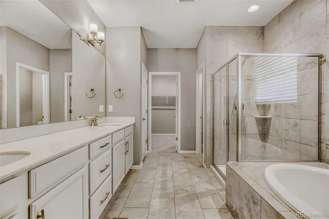 a spacious bathroom with a granite countertop sink a toilet a mirror and shower