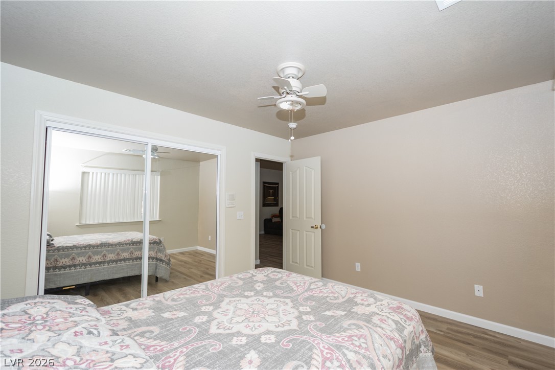 2381 Tough Boy Road Pahrump, NV 89060 - Photo 21 of 44 This spacious bedroom offers ample natural light and a comfortable atmosphere for rest and relaxation.