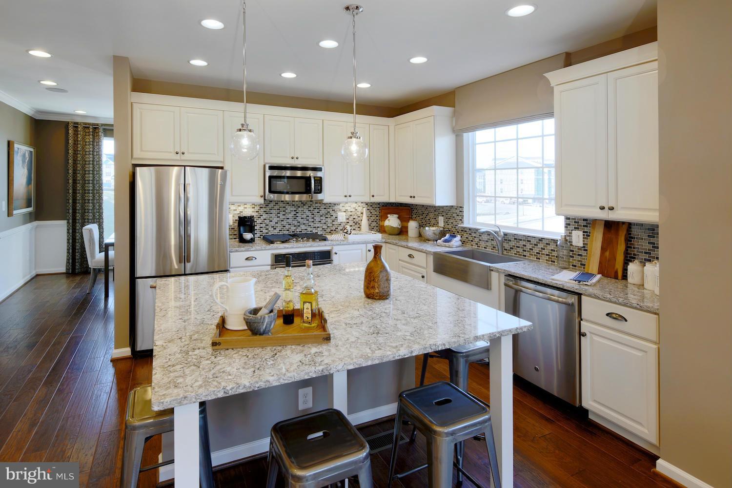 9057 Connor House Road Manassas, VA 20111 - Photo 2 of 10 a kitchen with stainless steel appliances granite countertop a stove refrigerator sink and cabinets