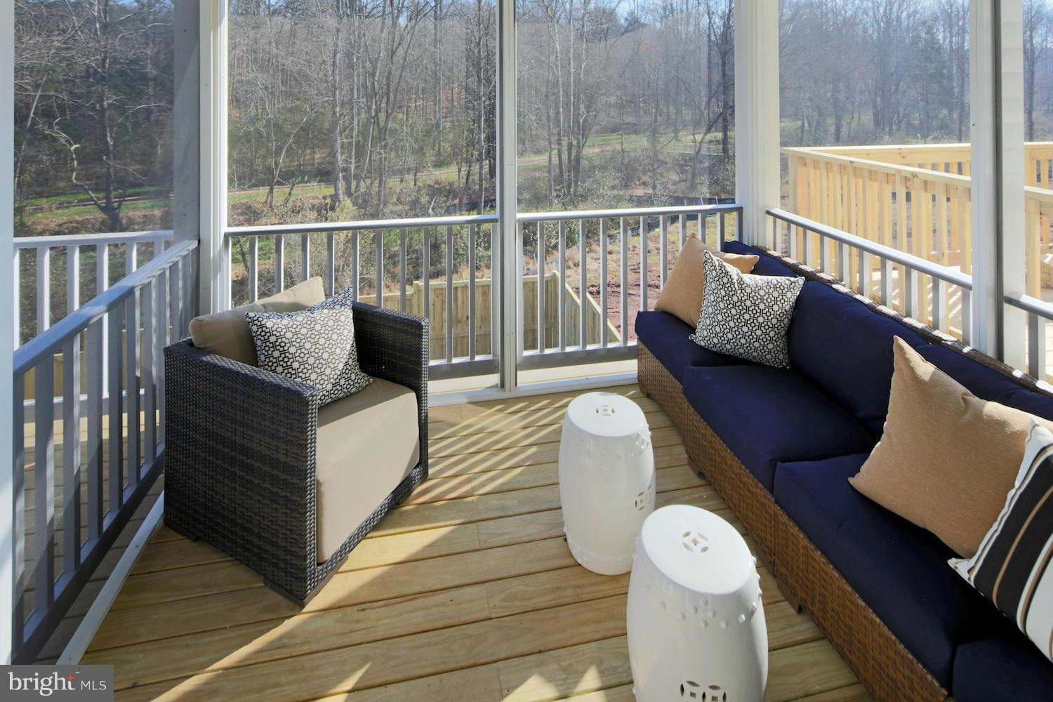 9057 Connor House Road Manassas, VA 20111 - Photo 10 of 10 a balcony with wooden floor table and chairs