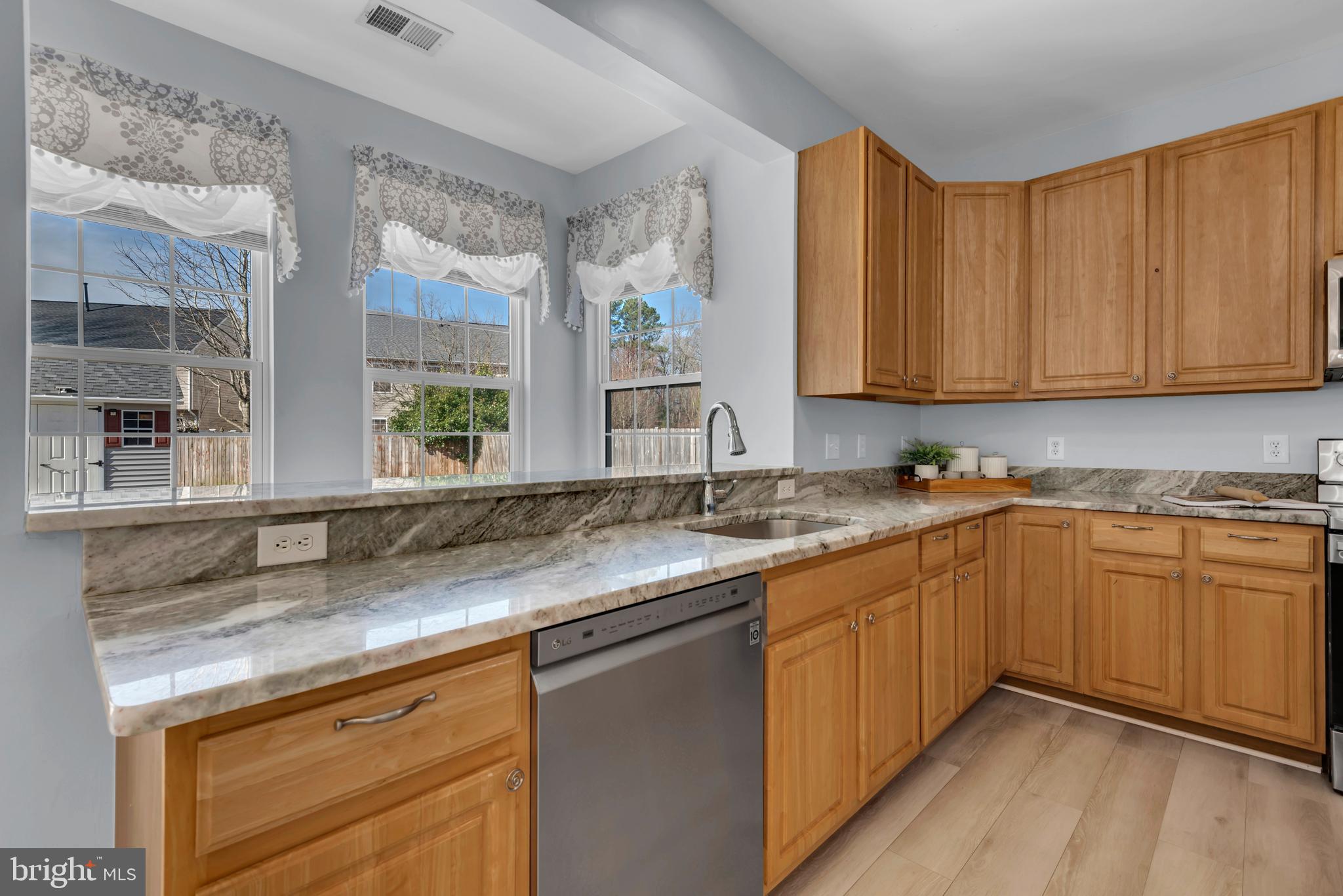 1104 Ruddy Duck Court Denton, MD 21629 - Photo 20 of 50 a kitchen with granite countertop a sink and cabinets