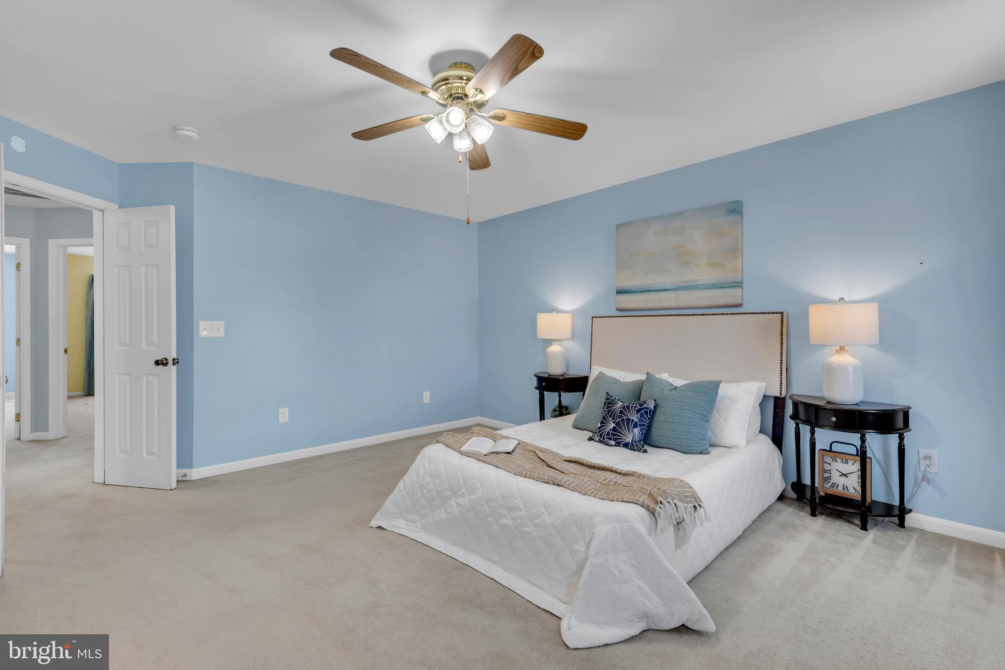 1104 Ruddy Duck Court Denton, MD 21629 - Photo 27 of 50 a bedroom with a large bed and a chandelier