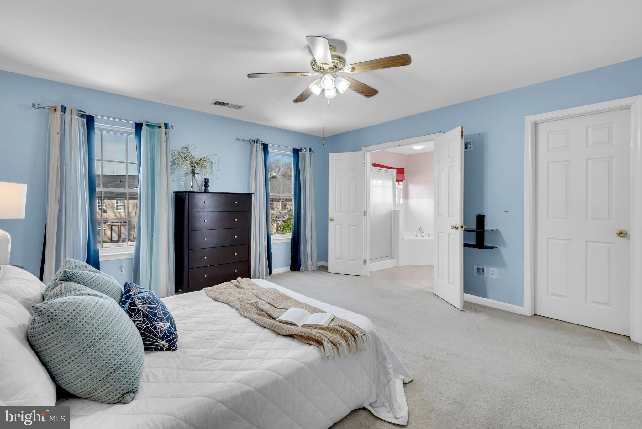 1104 Ruddy Duck Court Denton, MD 21629 - Photo 28 of 50 a bedroom with a large bed and a chandelier