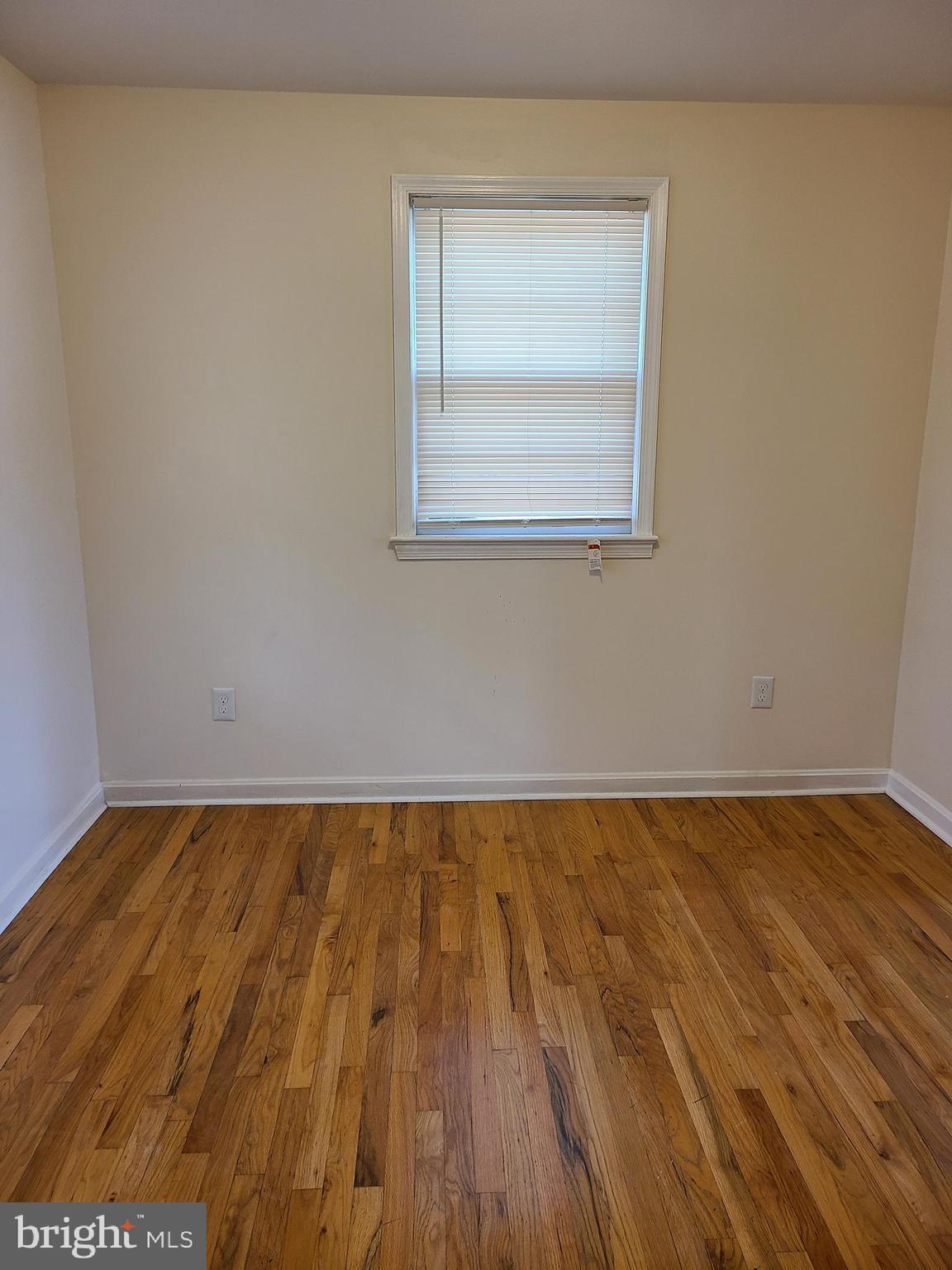 12305 Rock Point Road Newburg, MD 20664 - Photo 2 of 12 an empty room with wooden floor and cabinet