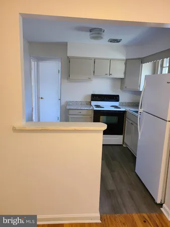 a kitchen with stainless steel appliances a refrigerator and a stove