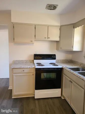 a stove top oven sitting inside of a kitchen