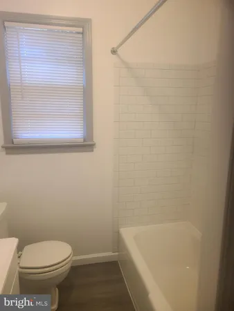 a bathroom with a toilet and a bathtub