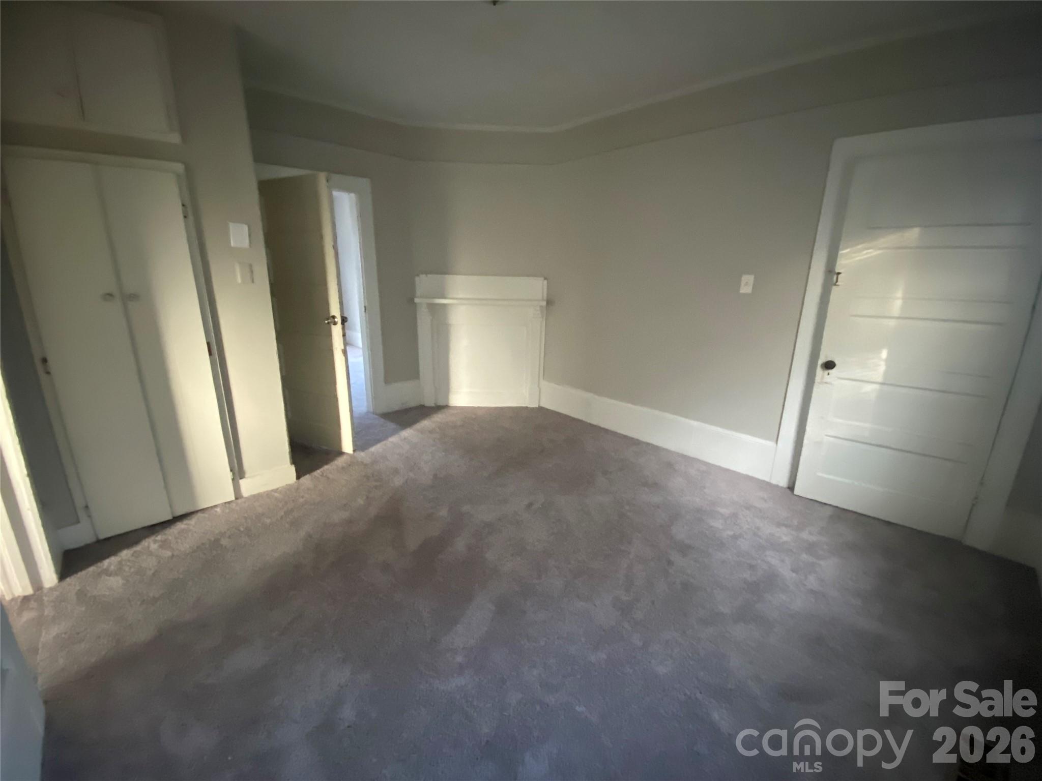 303 Rogers Lake Road Kannapolis, NC 28081 - Photo 14 of 20 a view of a big room with closet and wooden floor