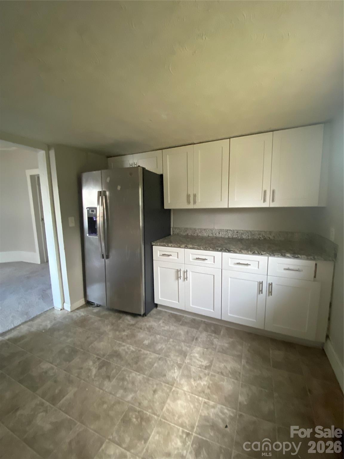 303 Rogers Lake Road Kannapolis, NC 28081 - Photo 19 of 20 a kitchen with granite countertop a refrigerator and a stove top oven