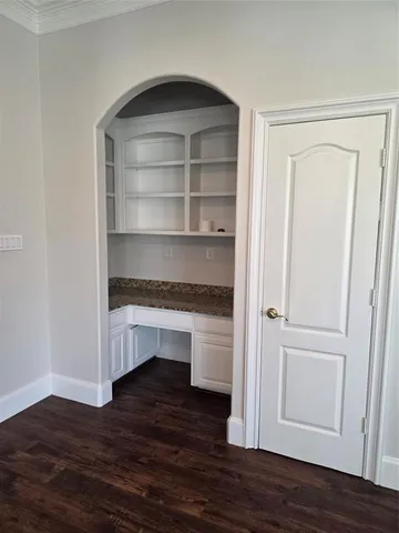 a view of storage and utility room with wooden floor