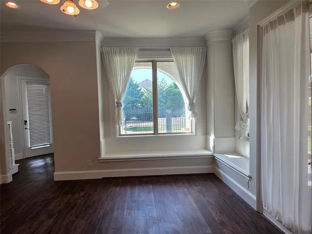 a view of room with window and hardwood floor