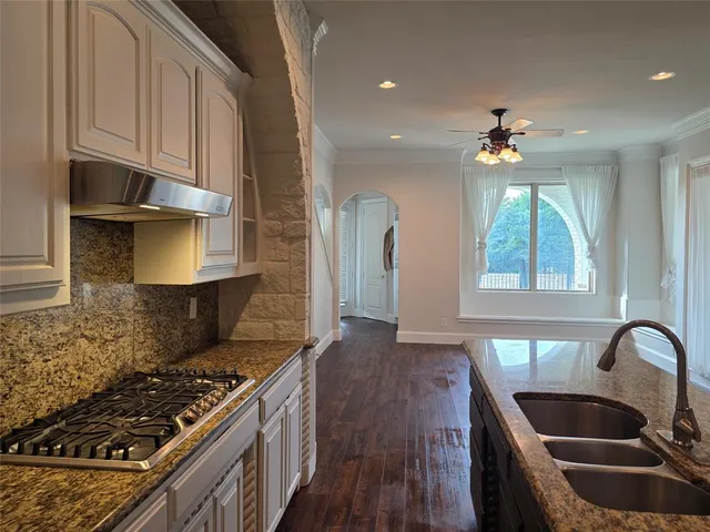 a kitchen with stainless steel appliances granite countertop a stove a sink and a refrigerator