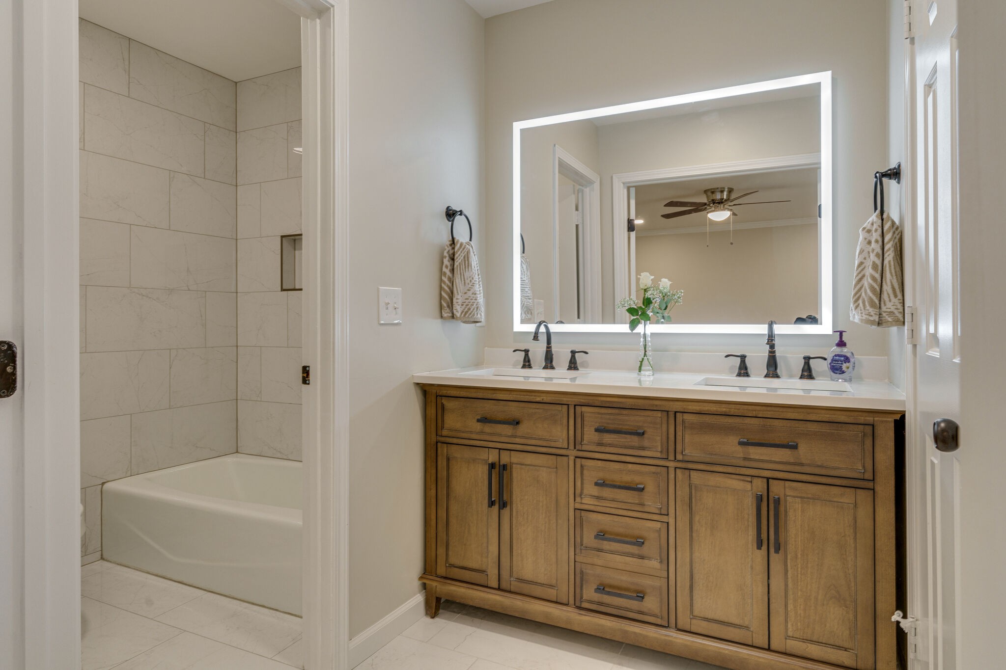 950 General George Patton Road Nashville, TN 37221 - Photo 1 of 34 a bathroom with a double vanity sink a mirror and a bathtub