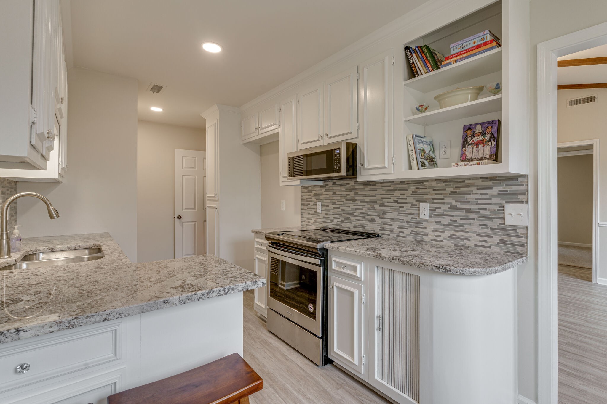 950 General George Patton Road Nashville, TN 37221 - Photo 2 of 34 a kitchen with stainless steel appliances granite countertop a stove and a sink