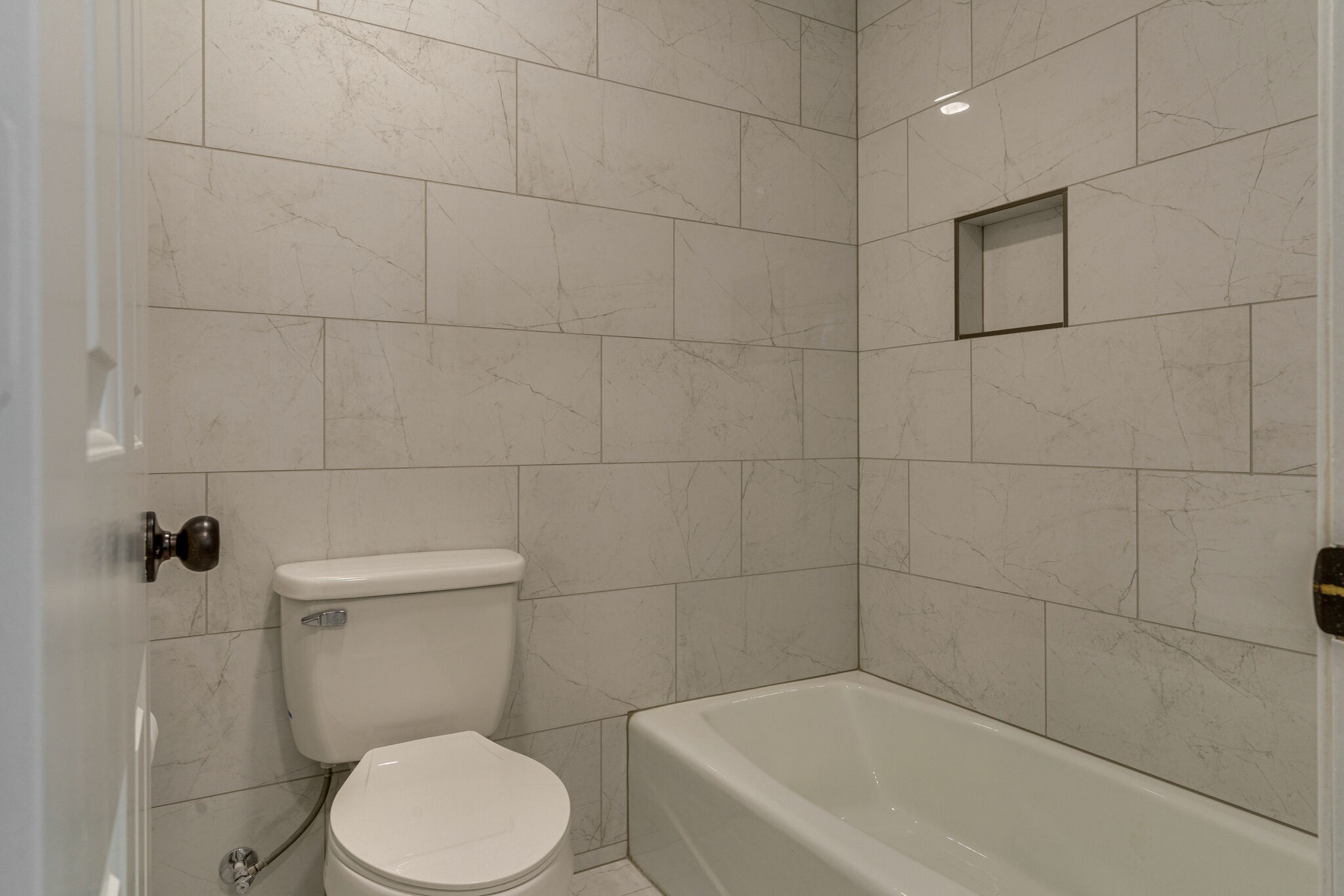 950 General George Patton Road Nashville, TN 37221 - Photo 12 of 34 a white toilet sitting next to a bath tub