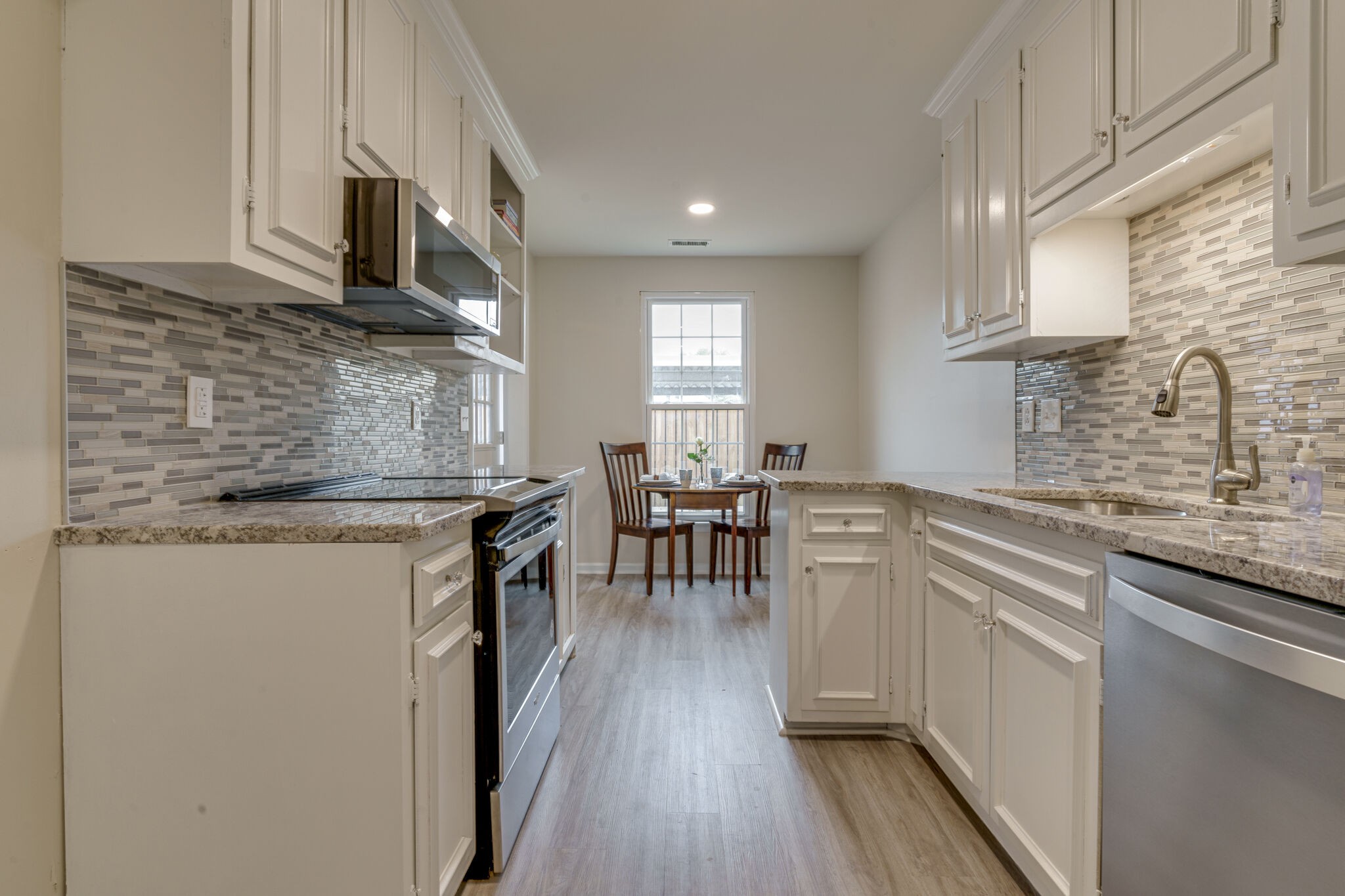 950 General George Patton Road Nashville, TN 37221 - Photo 17 of 34 a kitchen with cabinets and wooden floor