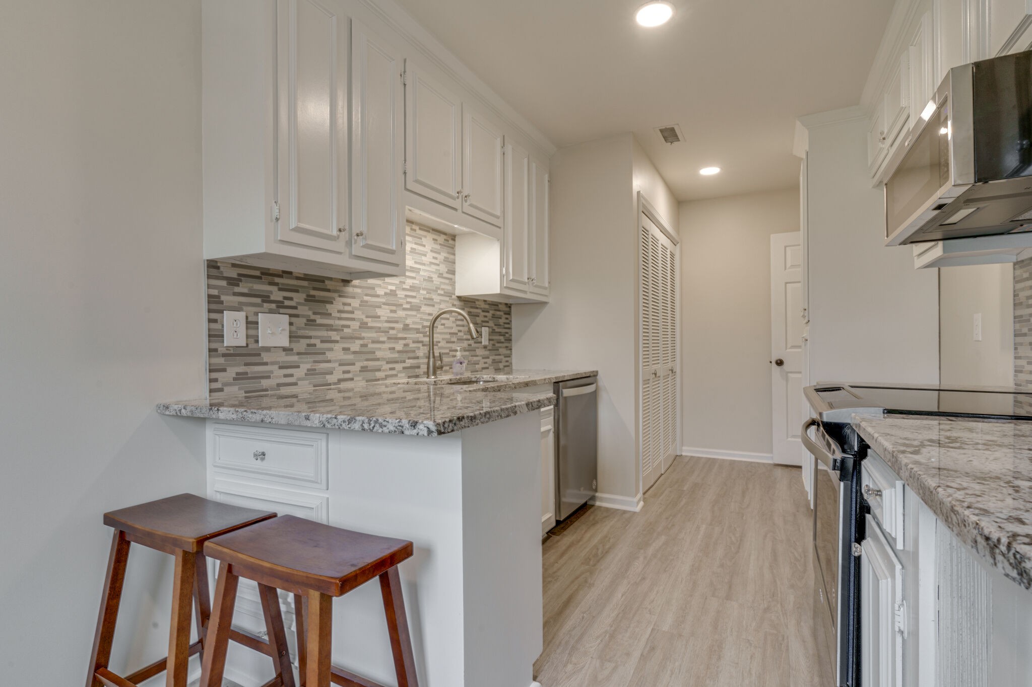 950 General George Patton Road Nashville, TN 37221 - Photo 19 of 34 a kitchen with stainless steel appliances granite countertop a sink stove and refrigerator