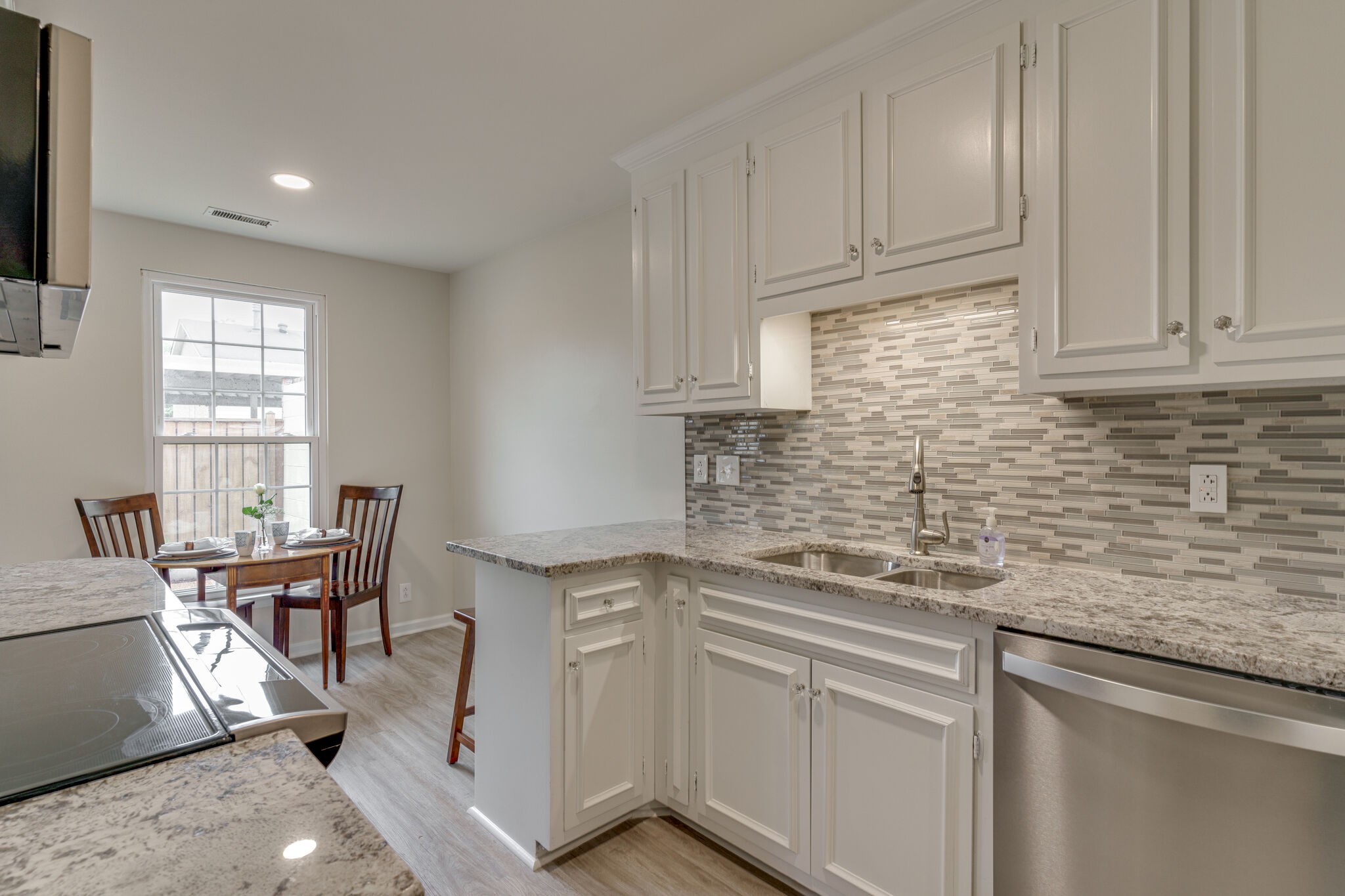 950 General George Patton Road Nashville, TN 37221 - Photo 20 of 34 a kitchen with stainless steel appliances granite countertop a sink stove and cabinets