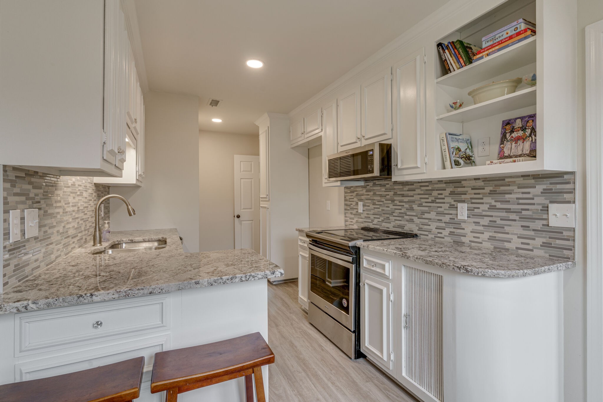 950 General George Patton Road Nashville, TN 37221 - Photo 21 of 34 a kitchen with stainless steel appliances granite countertop a stove and a sink