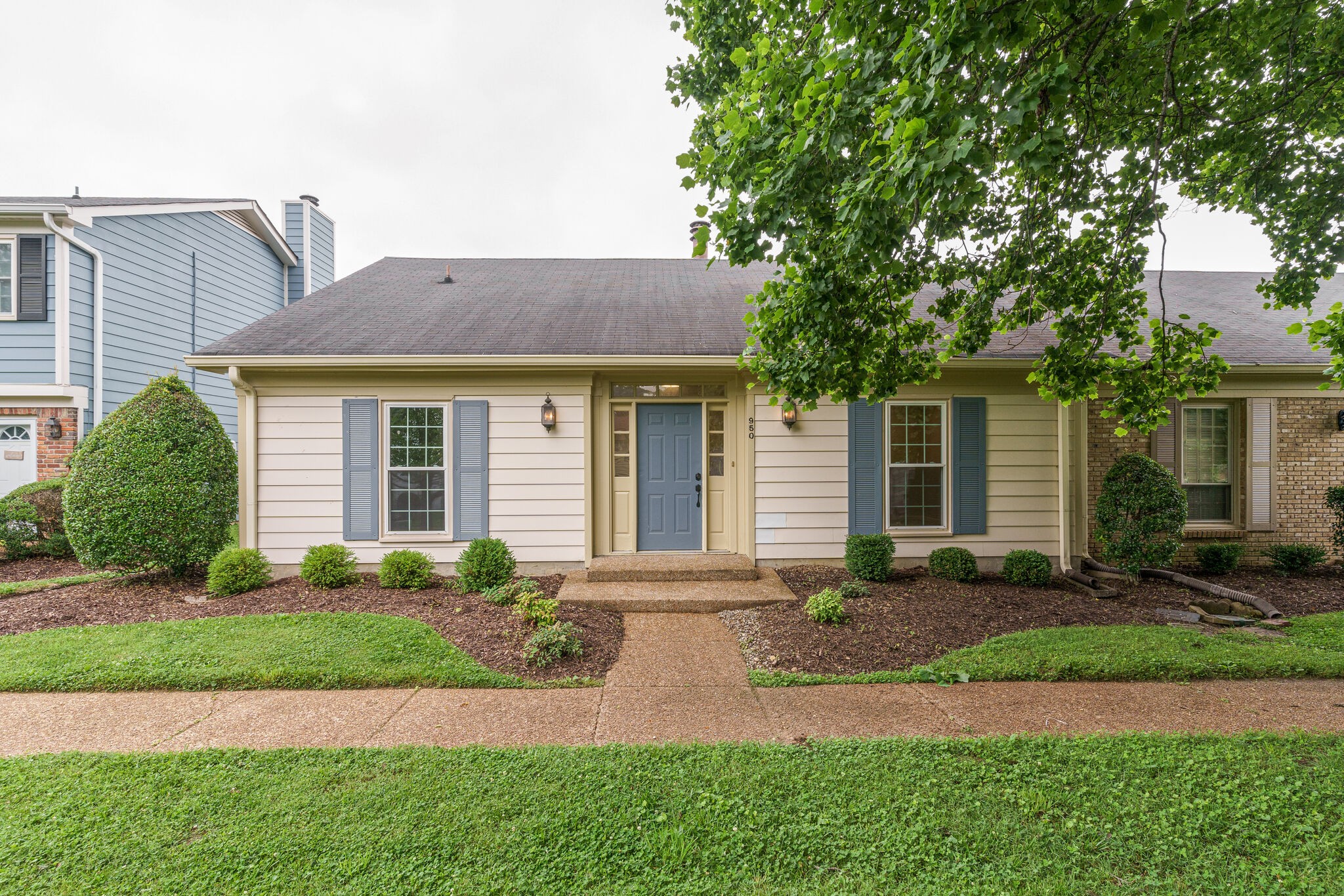 950 General George Patton Road Nashville, TN 37221 - Photo 4 of 34 a front view of a house with a yard and potted plants
