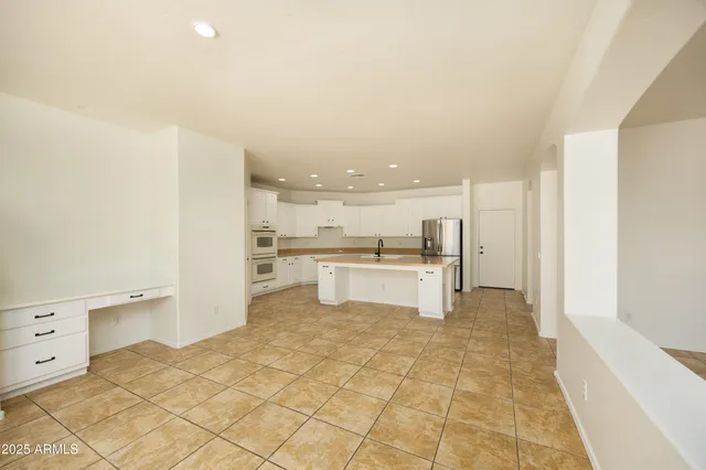 a kitchen with granite countertop a sink a counter top space stainless steel appliances and cabinets