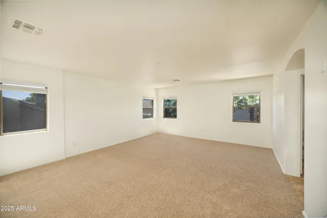 a view of an empty room and a window