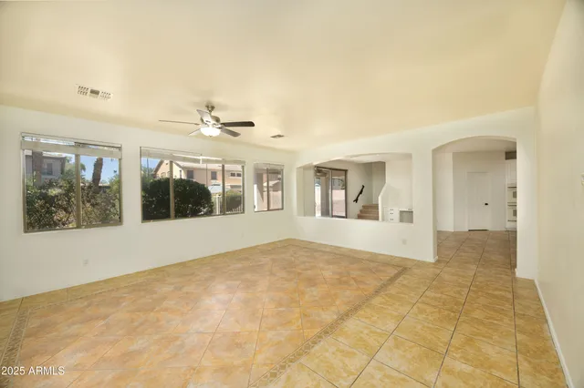an empty room with a empty space and kitchen view