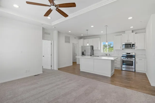 a view of kitchen with refrigerator cabinets and a ceiling fan