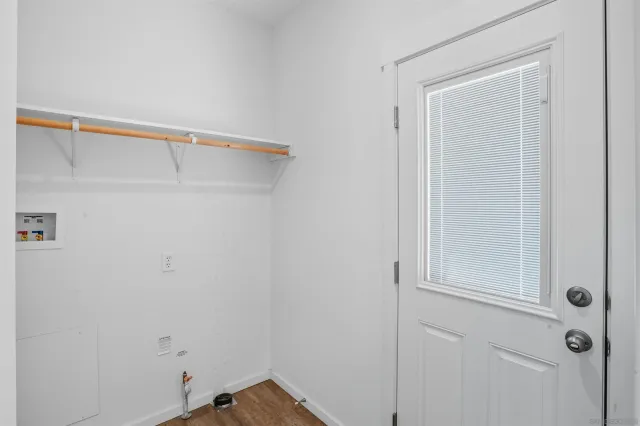 a large white kitchen with white cabinets and stainless steel appliances